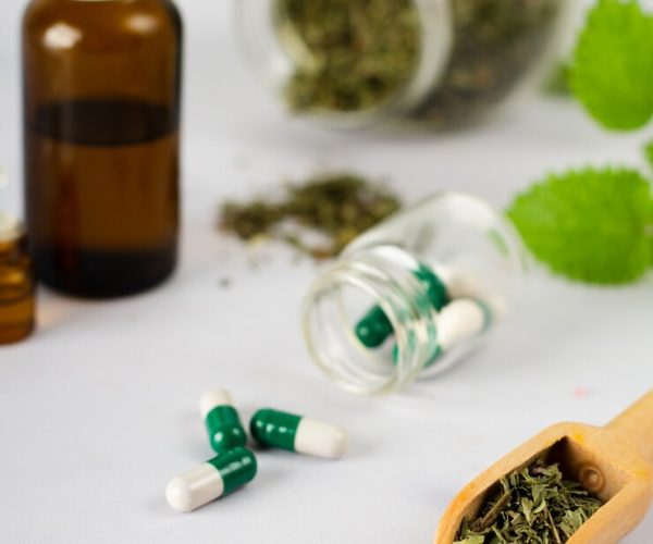 close-up-medical-capsules-with-herbs-table_23-2148431497